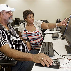 Active adult couple taking a computer class