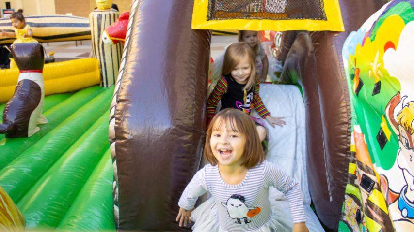 kids in a bounce house at the tumbleweed recreation center