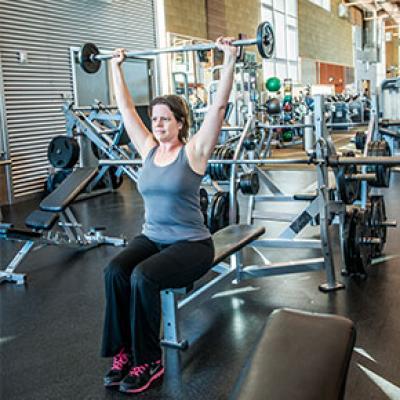 Patron lifting weights at Tumbleweed Recreation Center