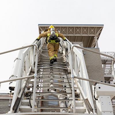 Chandler Firefighter climbing ladder truck