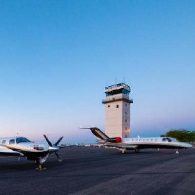 Two Private Jets Sitting in Front of the CHD Tower