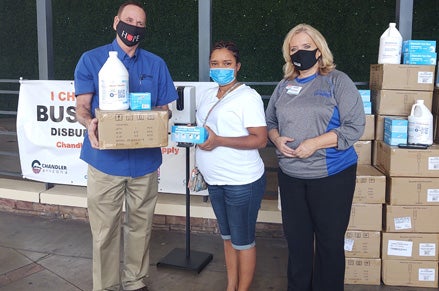 Mayor Kevin Hartke and Chandler Chamber of Commerce President Terri Kimble are pictured presenting a PPE kit to a Chandler business.