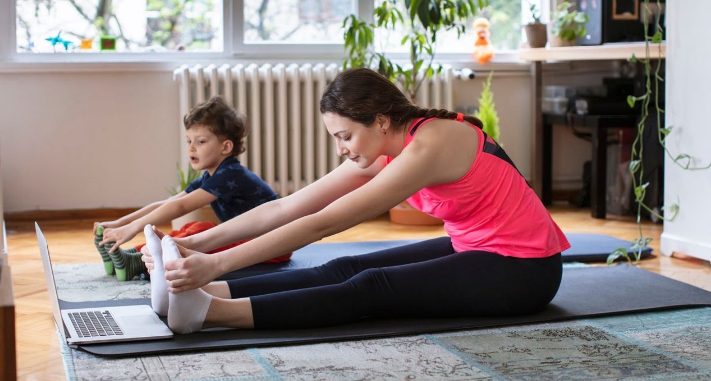 Mother and Child taking an online yoga class