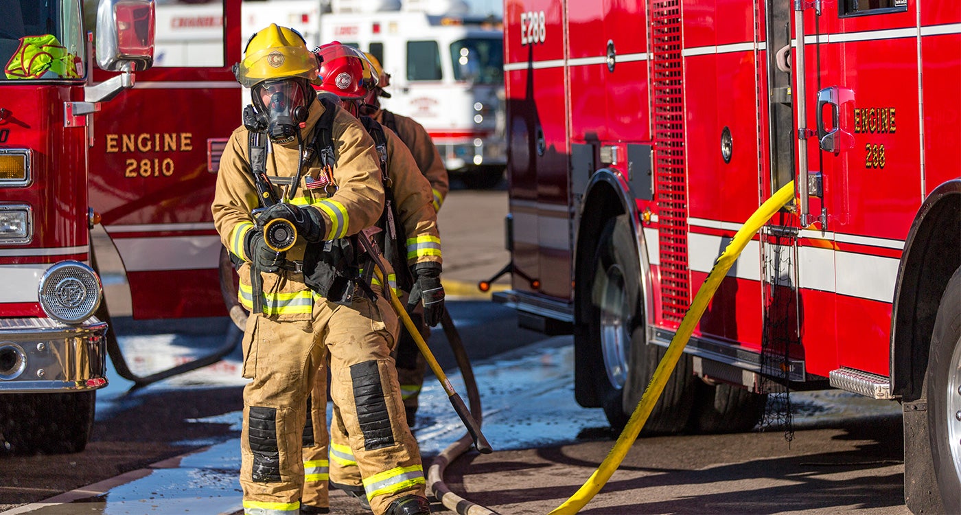 A Chandler firefighter with hose in hand ready for a training drill