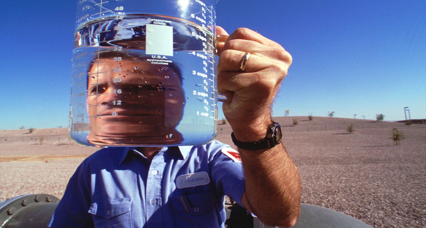 Man holding water in a beaker