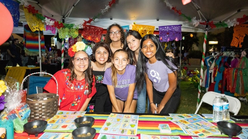 Group of festival-goers at a venor booth Group of festival-goers at a venor booth