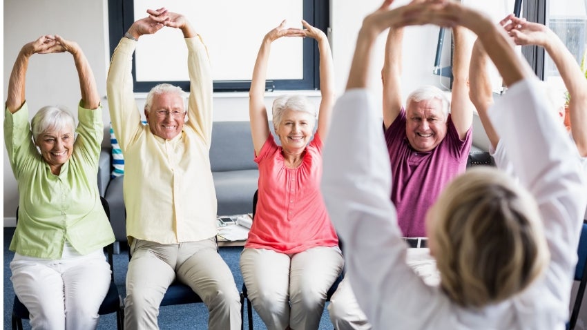 seniors doing fitness chair yoga 