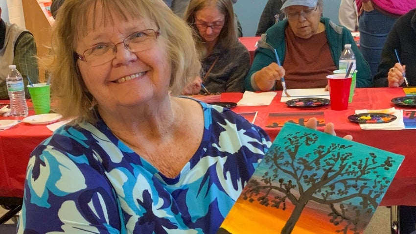 Chandler golden neighbor holding a DIY painting