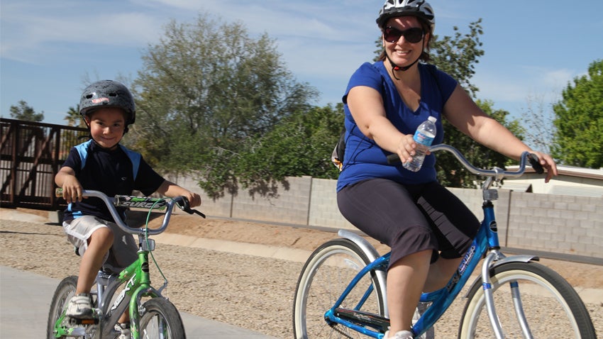 Mother and child riding bikes along Paseo Trail Mother and child riding bikes along Paseo Trail