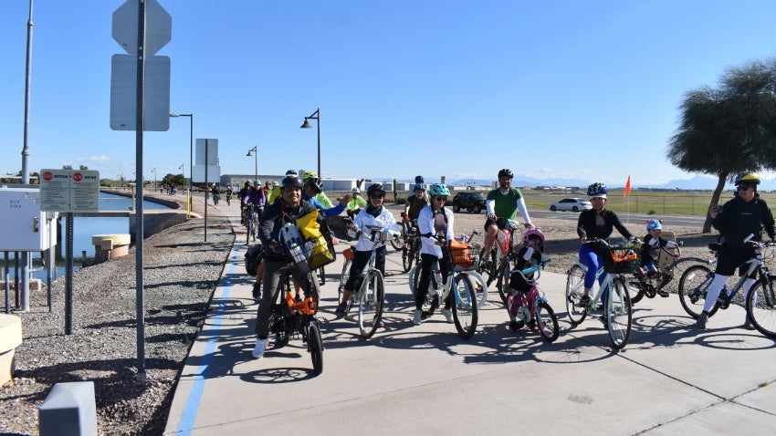 Family Bike Ride: Group along Paseo Trail Stop Sign Family Bike Ride: Group along Paseo Trail Stop Sign