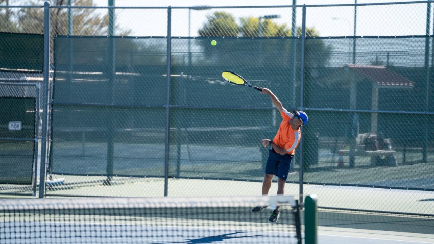 hitting a tennis ball
