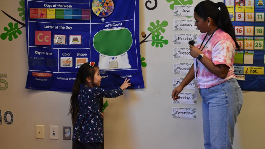 child pointing to numbers