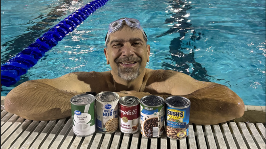 lap swimmer with cans of food for turkey swim