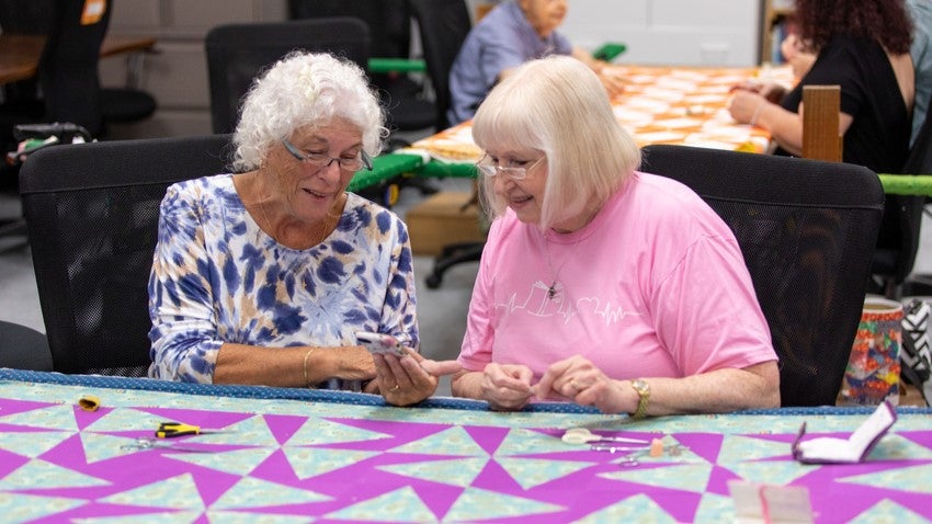 Two senior residents quilting Two senior residents quilting