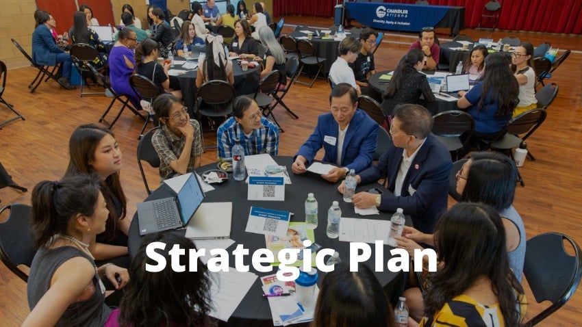 People sitting at roundtables during a conference with text: DEI Strategic Plan