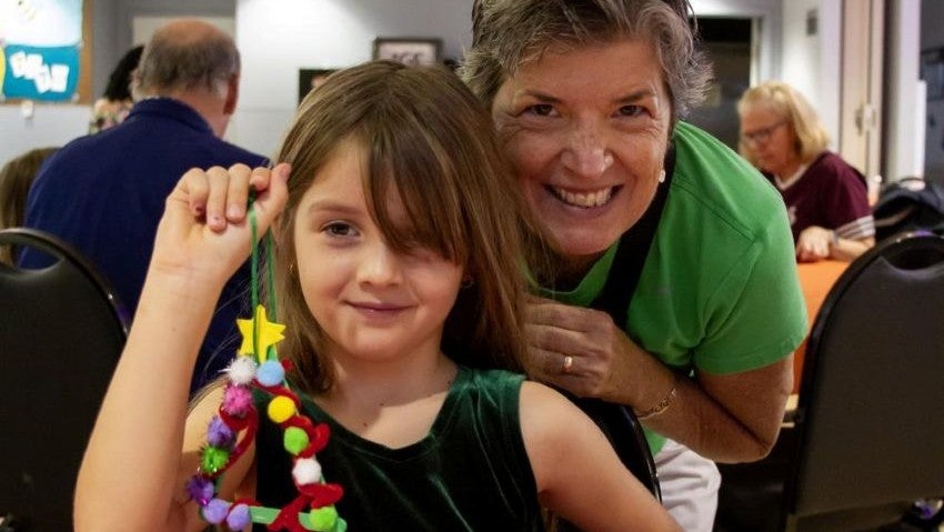 girl and grandma doing holiday craft