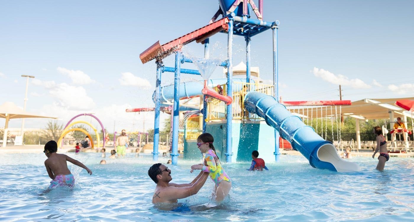 dad playing with daughter at Mesquite Groves Aquatic Center
