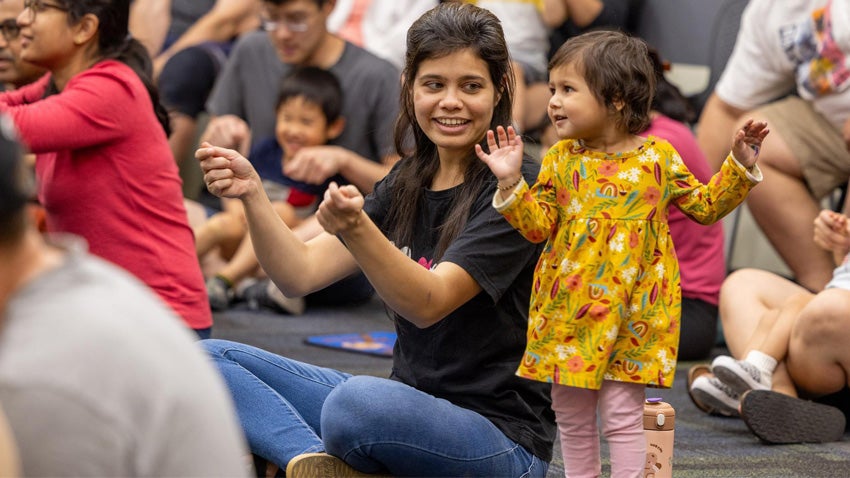 Young children and families participating in an event at a Chandler library