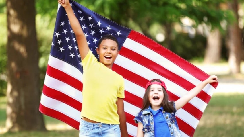 Two kids holding the American Flag