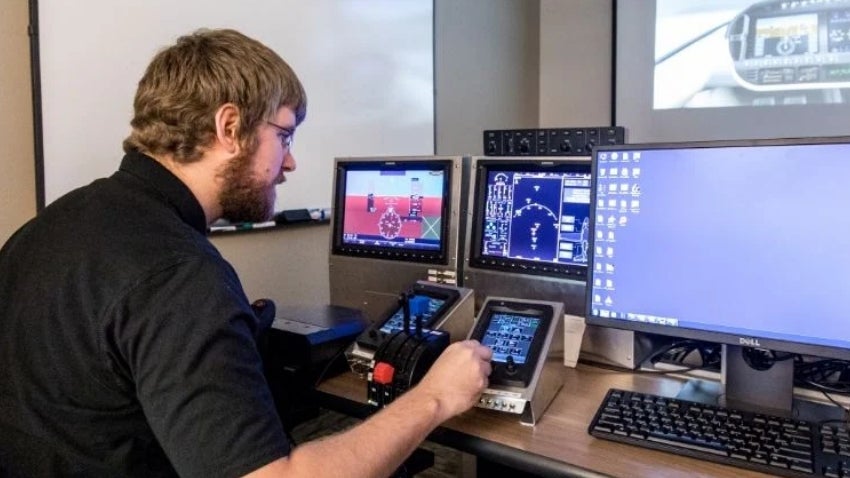 Man with working with multiple computer monitors