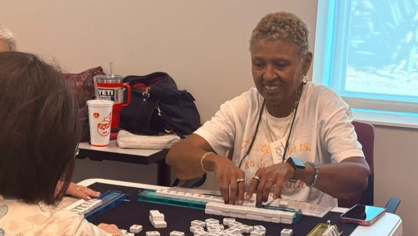 Senior enjoying a game of mahjong