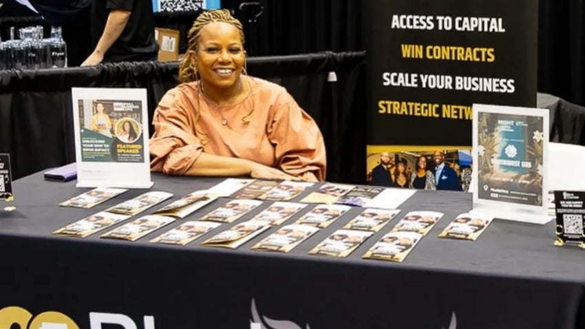 woman covering a black chamber of commerce booth