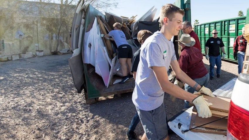 Young man helping to clean up a neighborhood