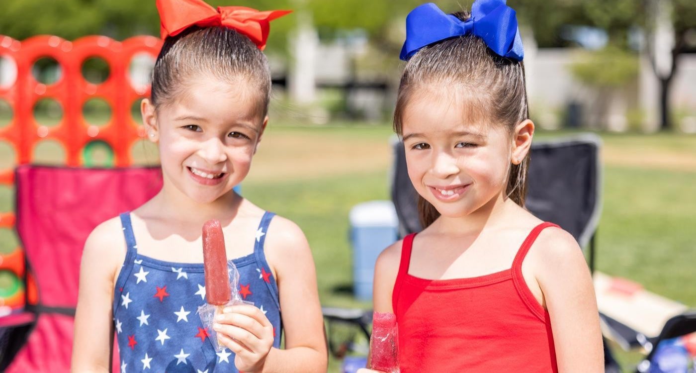 Twin grils eating popsicles