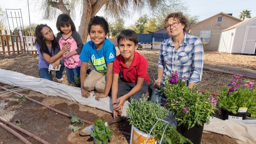 Children and instructor in the the community garden
