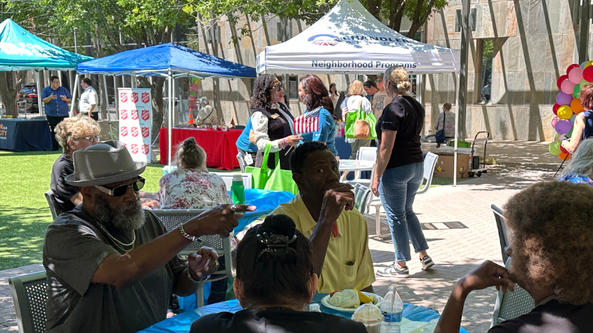 Neighbors in the City Hall courtyard with different city booths