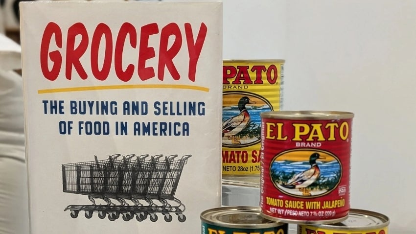 Grocery Book cover next to cans of El Pato hot sauce