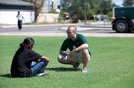 A Chandler navigator meeting a person experiencing homelessness in the field. 