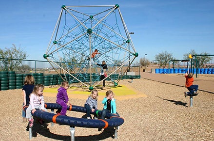 Children play at the Paseo Vista Recreation Area playgroud