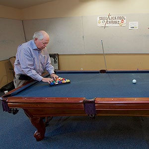 Active adult male playing pool