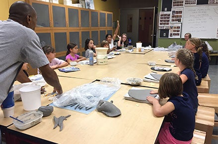 Youth camp participants in a ceramics class