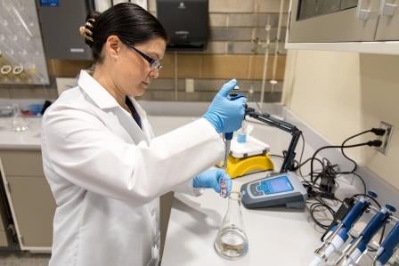 lab tech testing drinking water