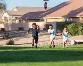 Kids running in a green belt
