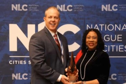 Councilmember Mark Stewart and Councilmember Christine Ellis accept DEI Award at the National League of Cities Conference