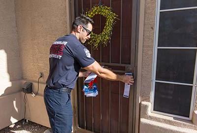 fireman at a doorstep during the Chandler Water Safety Walk