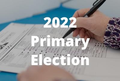 Photo of person filling out a ballot with text: 2022 Primary Election