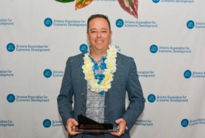 Micah Miranda with his EDDE award for  Economic Developer of the Year 