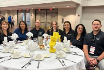 Neighborhood Resources Team seated at luncheon: Leah Powell, LaTisha Gilmore, Guy Jaques, Tawna Mower, Priscilla Quintana, Erica Barba and Phillip Hubbard