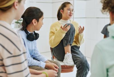 Group of four teens talking