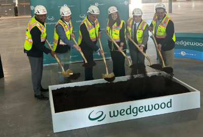 Wedgewood executives and Mayor Hartke at groundbreaking with shovels in hand wearing bright yellow vests