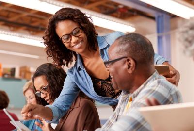 Female helping senior residents with tech questions