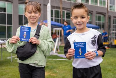 Kids holding passports at Chandler Innovation Fair