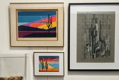 Two colorful abstract photos of cacti in frames and one abstract image of a cactus in black and white