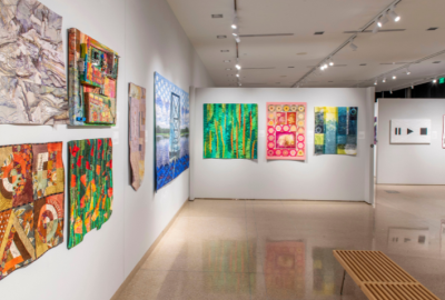 Colorful art quilts on wall at gallery
