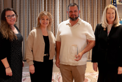 Korenna Tessier-Pothier; Regan Tillar; Jairo Garcia; Chief Justice Ann A. Scott Timmer with the award at the 2025 Court Leadership Conference. Not pictured: Presiding Judge Alicia Skupin and Ken Kung. 