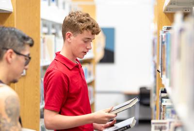 Chandler Public Library boy looking at books